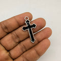 Minimal black enamel cross pendant with a polished silver border. A classic gothic piece for chains, bracelets, and keychains.
