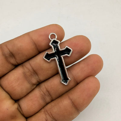 Minimal black enamel cross pendant with a polished silver border. A classic gothic piece for chains, bracelets, and keychains.
