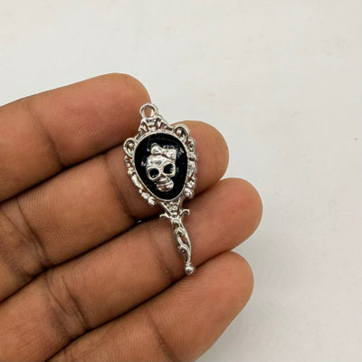 Vintage mirror-inspired pendant featuring a skull centerpiece with black detailing.