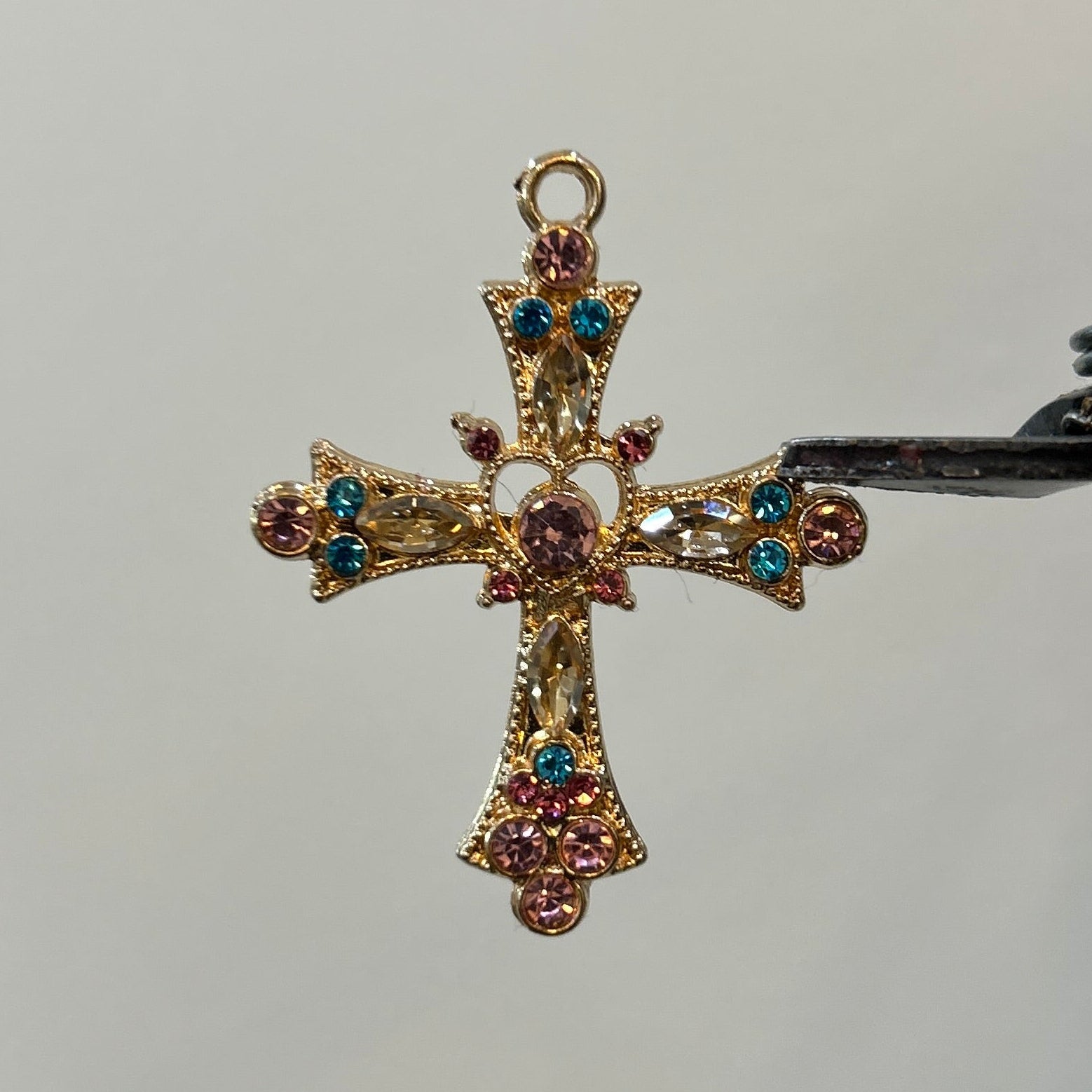 Gold viral cross pink blue zircon