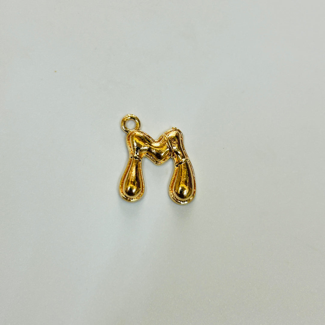 M gold alphabet