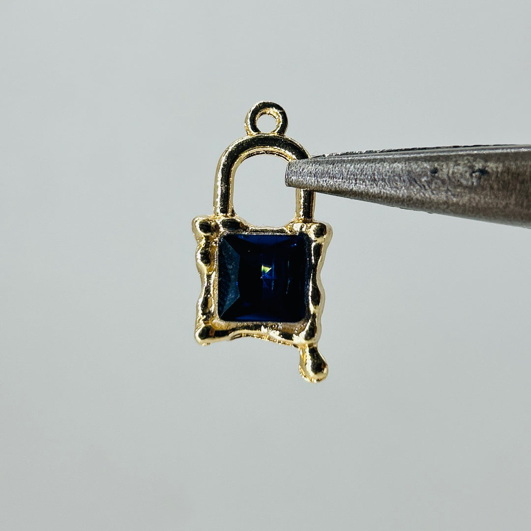 Gold lock charms blue stone