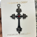Black cross with red stone